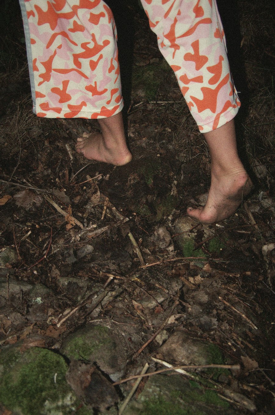 Bare feet on mossy forest ground