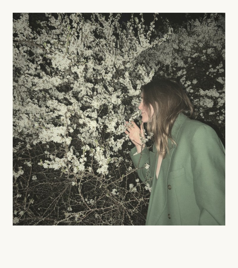 Elenore smelling spring blossoms at night